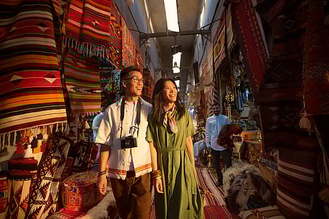 Couple shopping at Souq Al Badu‎ Market